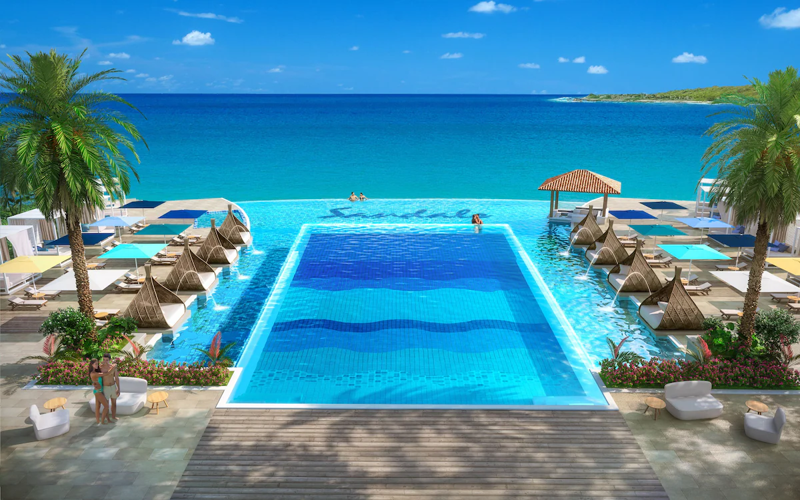Infinity pool at Sandals Royal Curaçao with ocean views and luxury poolside seating.